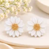 Daisy Gold-Knot Earrings on Cream Surface (1) Petal Daisy Stud Earrings